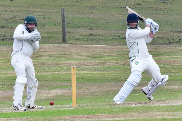 Sarisbury's Josh Hill hits out during their Village Cup win over Bramshaw. Pic: Mike Vimpany
