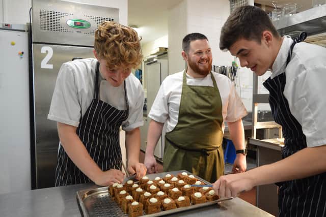 Apprentice Jack Breach, executive chef Simon Hartnett and apprentice Ketan Dixon-Whiteaway in the kitchen at the Queens Hotel in Southsea 