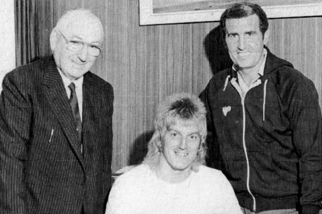 Alan Biley signs for Pompey in August 1982, watched by chairman John Deacon (left) and manager Bobby Campbell (right)