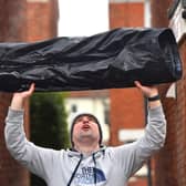 Marcin Jedrysiak from Portsmouth with a pair of his trousers which froze solid in his garden last night, as temperatures across the UK plummeted to their lowest point in two decades. Picture: Roger Arbon/Solent News & Photo Agency