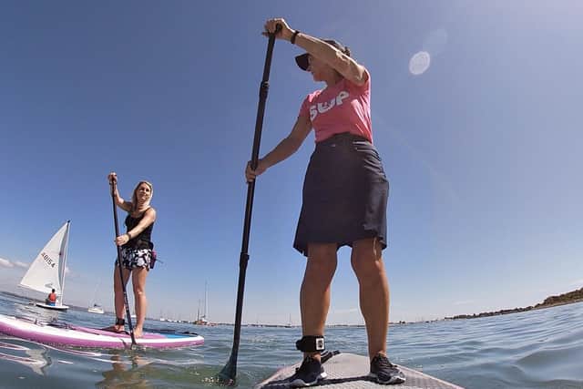 Members of Hayling Island Sup Girls group paddle boarding. 