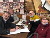 Cllr Lee Hunt, left, signs a petition with Helen King, right, calling on banking bosses to talk to city leaders to try and support the re-opening of a bank in North End.