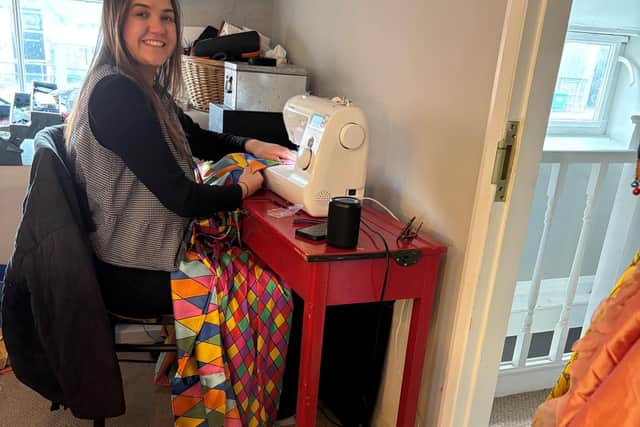 Costume design assistant Erin Hill makes Harlequinetta’s colourful gown that the mannequin will wearing to greet guests at at Palace House