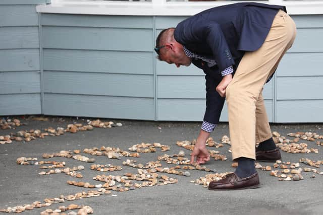 Pictured is Graham Culton as he creates a pebble message as part of the Help for Heroes day in Southsea.
Picture: Sam Stephenson