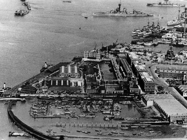Aerial view of South Railway Jetty with the railway viaduct and swing bridge. The ship swinging is a dreadnought.