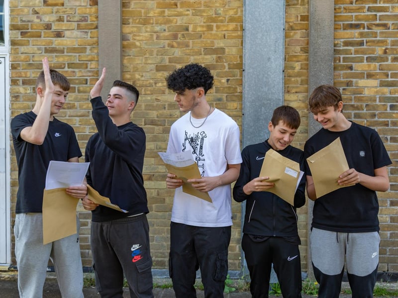 High fives between Crookhorn College students on GCSE results day. Pictured: Josh Holden, Jack Livesesy, Harvey Ross, Sam Tice and Will Carter. Picture: Mike Cooter (240823)
