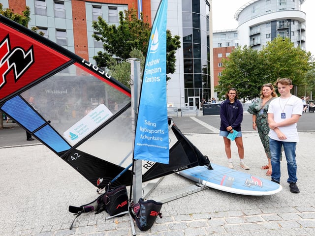 Milly Lindup, Rebecca Ebsworth and Jacob Gates discuss windsurfing tuition on the Andrew Simpson stand. Picture: Chris Moorhouse (160825-14)