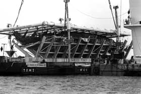 The Mary Rose in its cradle being brought ashore by a barge in October 1982. Picture: The News PP3741