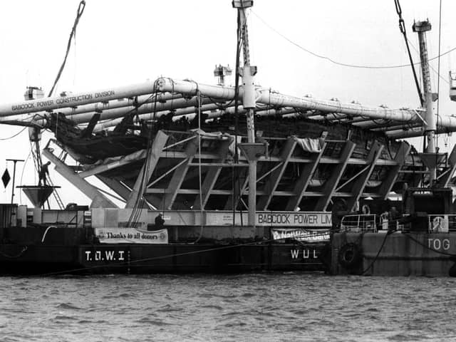 The Mary Rose in its cradle being brought ashore by a barge in October 1982. Picture: The News PP3741