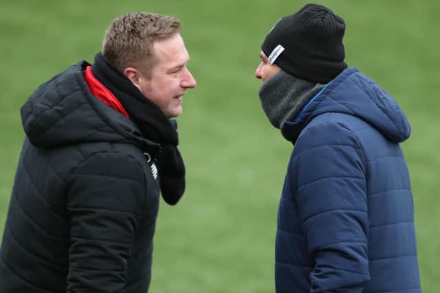 Hawks manager Paul Doswell, right, goes face to face with Ebbsfleet's Dennis Kutrieb prior to their red cards. Photo by Dave Haines