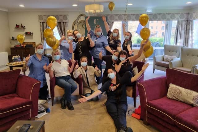 Staff and residents celebrate the award success.