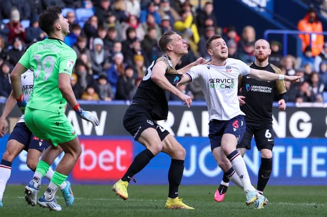Michael Morrison battles for possession in Pompey's defeat at Bolton. Picture: Simon Davies/ProSportsImages