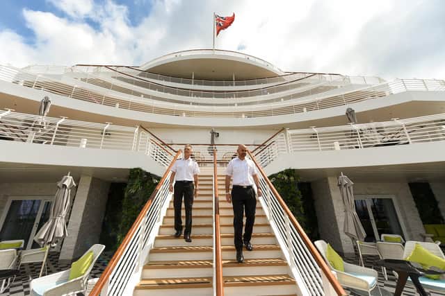 Saga’s brand-new cruise ship, ‘Spirit of Adventure, which was named with a traditional bottle smashing ceremony at Portsmouth International Port on July 19. Pictured is stern staircase and senior crew. 
