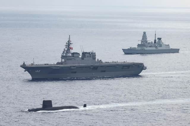 Pictured: From top to bottom are HMS Defender, JS Ise and an Oyashio Class submarine during Exercise Pacific Crown in the Philippine Sea.