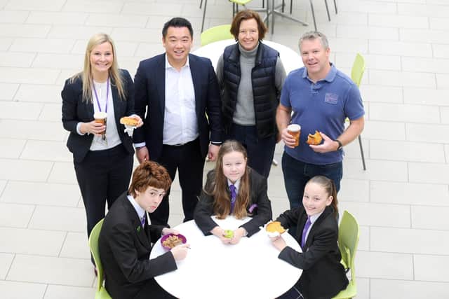 Representatives from the FatFace Foundation attended Havant Academy's daily breakfast club to celebrate its donation of £30,000 to the Magic Breakfast. The charity's contribution will pay for 100,000 breakfasts for schoolchildren across the nation who arrive at school too hungry to learn - starting in Havant. Pictured, from back left, is Victoria Adams, head of school, Alan Mak, Havant MP, Carmel McConnell MBE, founder of Magic Breakfast and Ian Williams, chairman of the FatFace Foundation. From front left, with pupils Ethan Comben, 15, Chloe Stanford, 11 and Raya Oakey, 12. Picture: Sarah Standing (280220-6214)