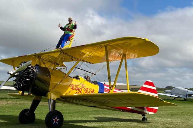Samantha Tanner from Wave 105 Cash for Kids does a wing walk dressed as Wonder Woman