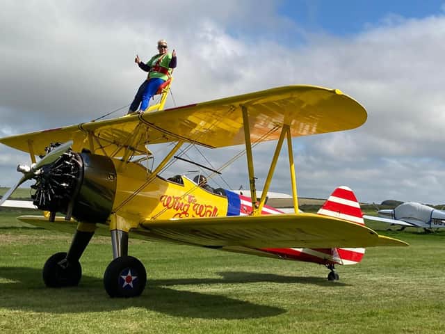 Samantha Tanner from Wave 105 Cash for Kids does a wing walk dressed as Wonder Woman