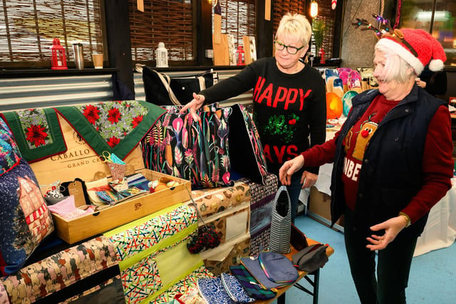 Pictured is: Denise O'Brien shows Cherie Chapman some of the goods at her stall, O'Brien Hand Made Gifts.
 
Picture: Keith Woodland (031221-3)