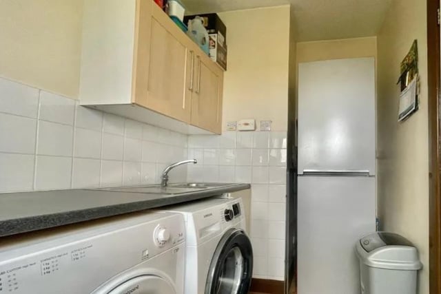The utility room has space for a washer, tumble drier and tall fridge-freezer.