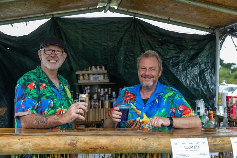 Pictured: The Hawaiian shirts worn by Grant Connell (56) and Gary Scott (58) were not enough to summon Hawaiian weather at the Wave gin bar. 
Picture: Mike Cooter (050823)