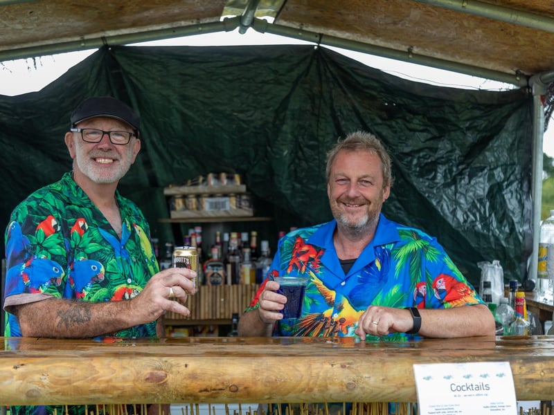 Pictured: The Hawaiian shirts worn by Grant Connell (56) and Gary Scott (58) were not enough to summon Hawaiian weather at the Wave gin bar.
Picture: Mike Cooter (050823)