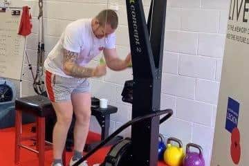 Navy veteran Dan Fallon pictured tackling one of 11 marathons on the punishing SkiErg fitness machine.