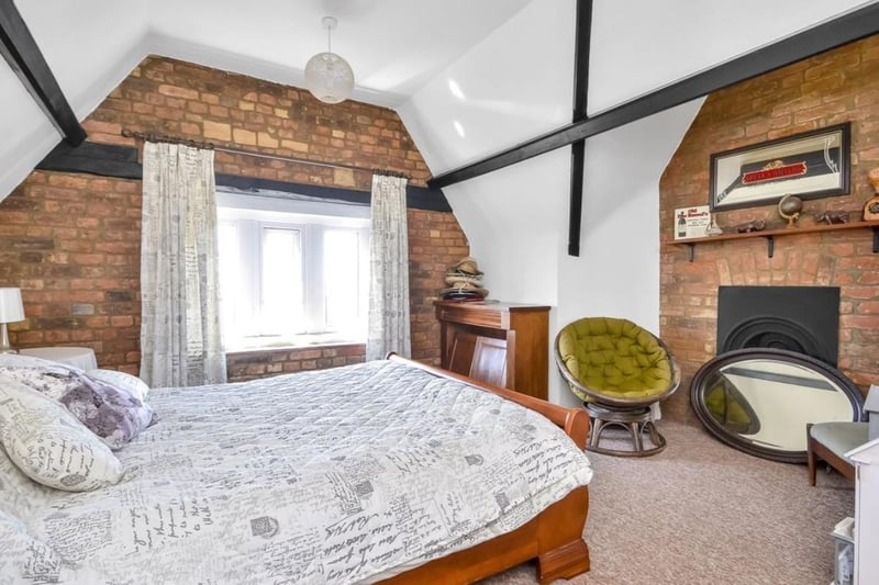 The listing says: "On entering the house through a set of twin arched doors, you are led into a foyer with a further arched door leading to hallway with staircase rising to the upper floors and doors to primary rooms including a 23’ sitting room with feature bay window, dining room, kitchen and conservatory on the ground floor."