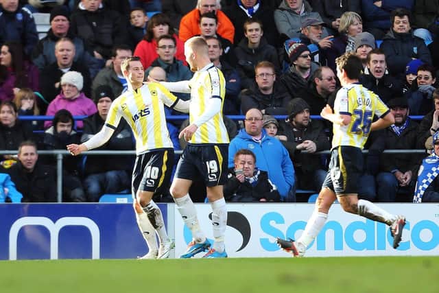 Billy Bodin, left, has just scored Torquay's winner at Fratton Park in February 2014