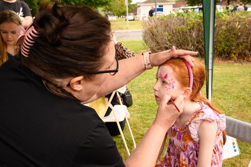 Amy Grigg, 6, gets her face painted.