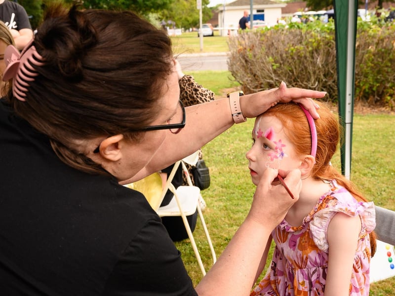 Amy Grigg, 6, gets her face painted.