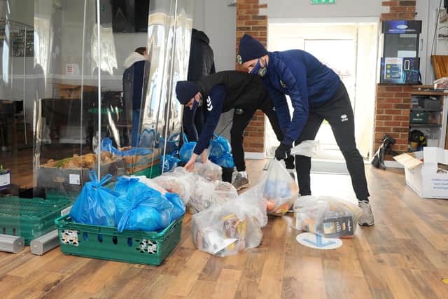 Gosport Borough FC players Joe Lea and Pat Suraci help sort out food parcels for the 'Feed a Family in Need' scheme. Picture: Sarah Standing