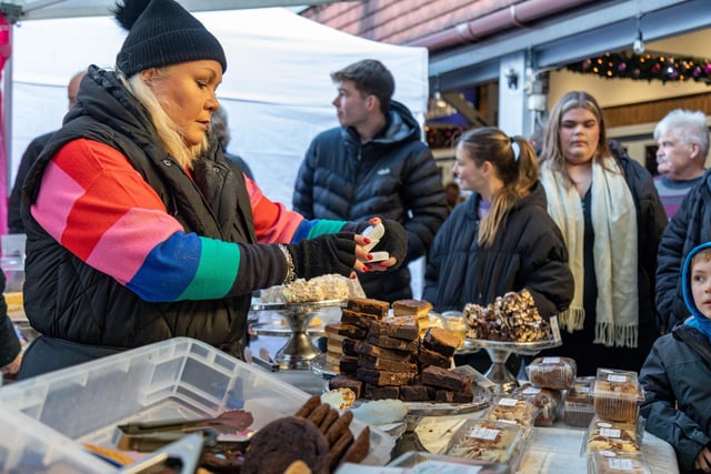 Hungry shoppers take advantage of the posh snacks at the Festival of Christmas in Port Solent. Picture: Mike Cooter (091223)