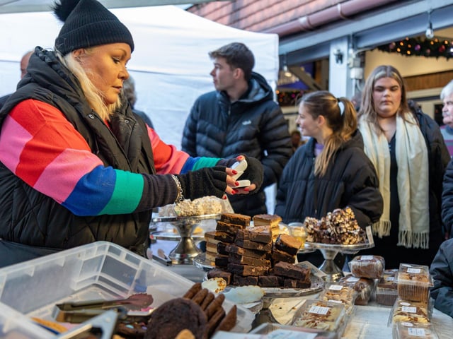 Hungry shoppers take advantage of the posh snacks at the Festival of Christmas in Port Solent. Picture: Mike Cooter (091223)