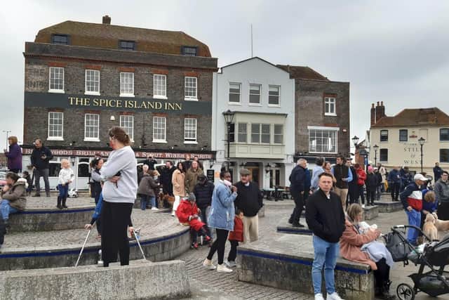 Crowds gather in Bath Square, Old Portsmouth, to watch the salute. Picture: Alan Cooper
