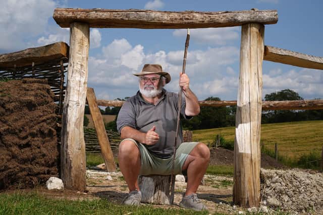 Veteran Kevin Reilly from Southsea, sits in front of the beginnings of a bronze age roundhouse as he makes the finishing touches to a hand made hunting spear Picture: Andrew Matthews/PA Wire