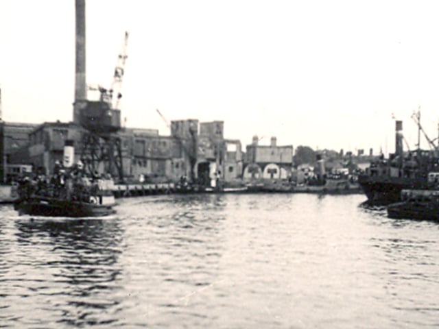 The Gosport ferry departing from the Camber, Old Portsmouth, circa 1950. Much bomb damage from the war still remains in the background.