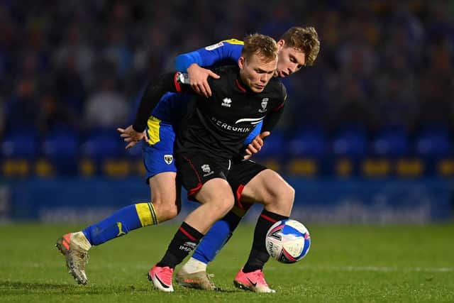 Anthony Scully, pictured battling against AFC Wimbledon's Daniel Csoka, is one of three players Pompey have paid transfer fees for this summer. Picture: Justin Setterfield/Getty Images.