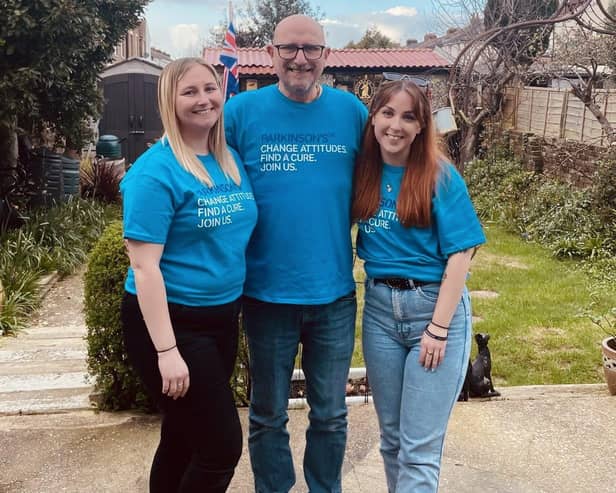 John with his daughters Amie (L) and Jess (R)