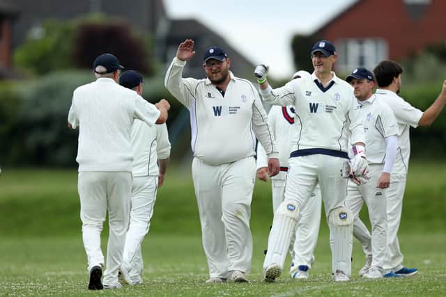 Portsmouth Community celebrate the fall of a Clanfield wicket. Picture: Chris Moorhouse