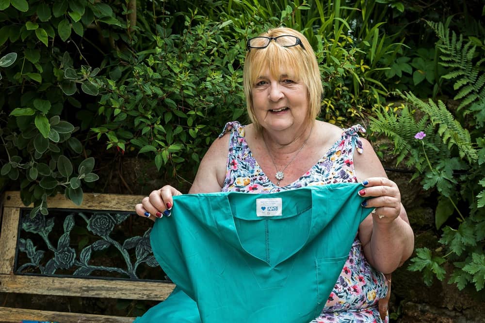 Lin Gell, who has been awarded the British Empire Medal, shows off one of the scrubs produced by Team Scubbers during the pandemic. Picture: Mike Cooter (080621)