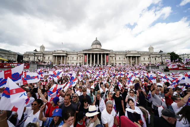 England fans wave flags during a fan celebration to commemorate England's historic UEFA Women's EURO 2022 triumph in Trafalgar Square, London. Picture date: Monday August 1, 2022.