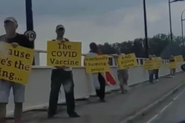 Protesters staged a bizarre anti-vaccine rally on a bridge into Hayling Island on Sunday.