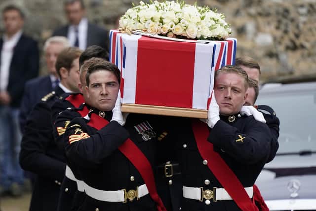 Pallbearers carry the coffin of Major General Matthew Holmes, the former head of the Royal Marines, out of Winchester Cathedral in Hampshire following his funeral service. Andrew Matthews/PA Wire