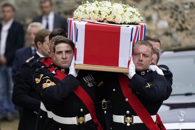 Pallbearers carry the coffin of Major General Matthew Holmes, the former head of the Royal Marines, out of Winchester Cathedral in Hampshire following his funeral service. Andrew Matthews/PA Wire