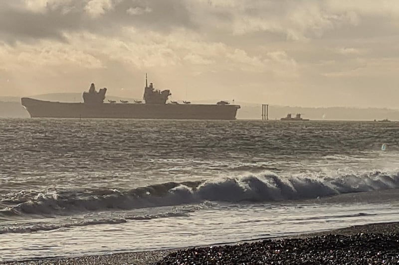 HMS Queen Elizabeth leaves Portsmouth as seen from Eastney.
