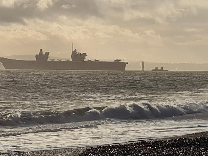 HMS Queen Elizabeth leaves Portsmouth as seen from Eastney.