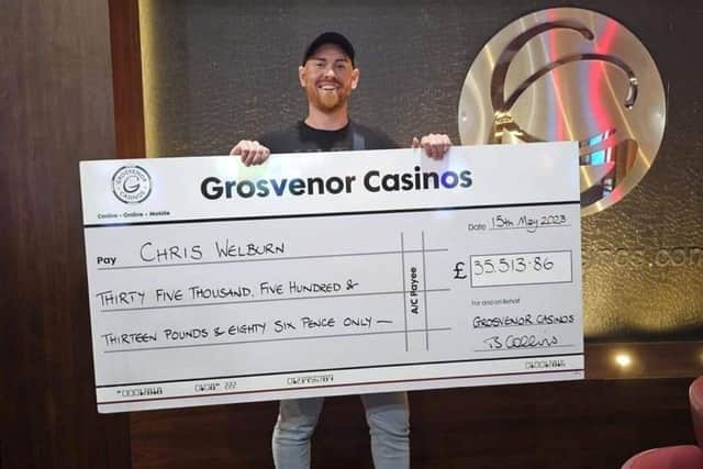 Christopher Welburn, 33, with his cheque for £35,500 after winning the minor three-card poker jackpot at Grosvenor Casino in Gunwharf Quays. Picture: Natalie Harman.