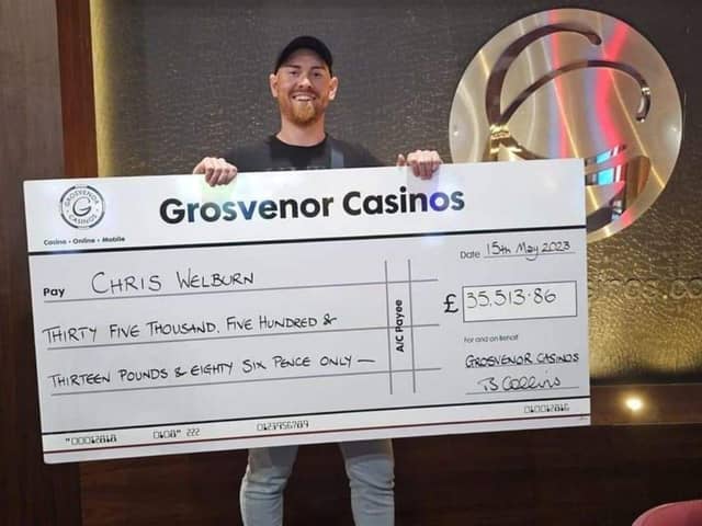 Christopher Welburn, 33, with his cheque for £35,500 after winning the minor three-card poker jackpot at Grosvenor Casino in Gunwharf Quays. Picture: Natalie Harman.