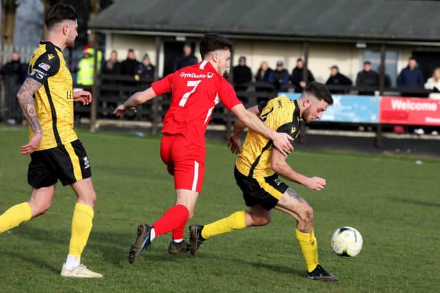 Horndean's Ben Anderson (middle) puts pressure on Harry Sargeant.
Picture: Sam Stephenson.
