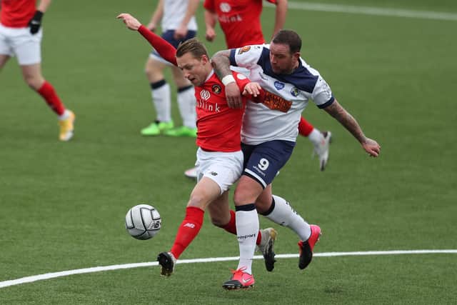 Danny Kedwell, right, battles for possession with Fleet's Chris Solly, who was later sent off for retaliation after being fouled by Theo Widdrington. Photo by Dave Haines